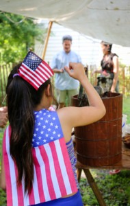 July 4th celebration Girl holding American flag wearing an american flag shirt